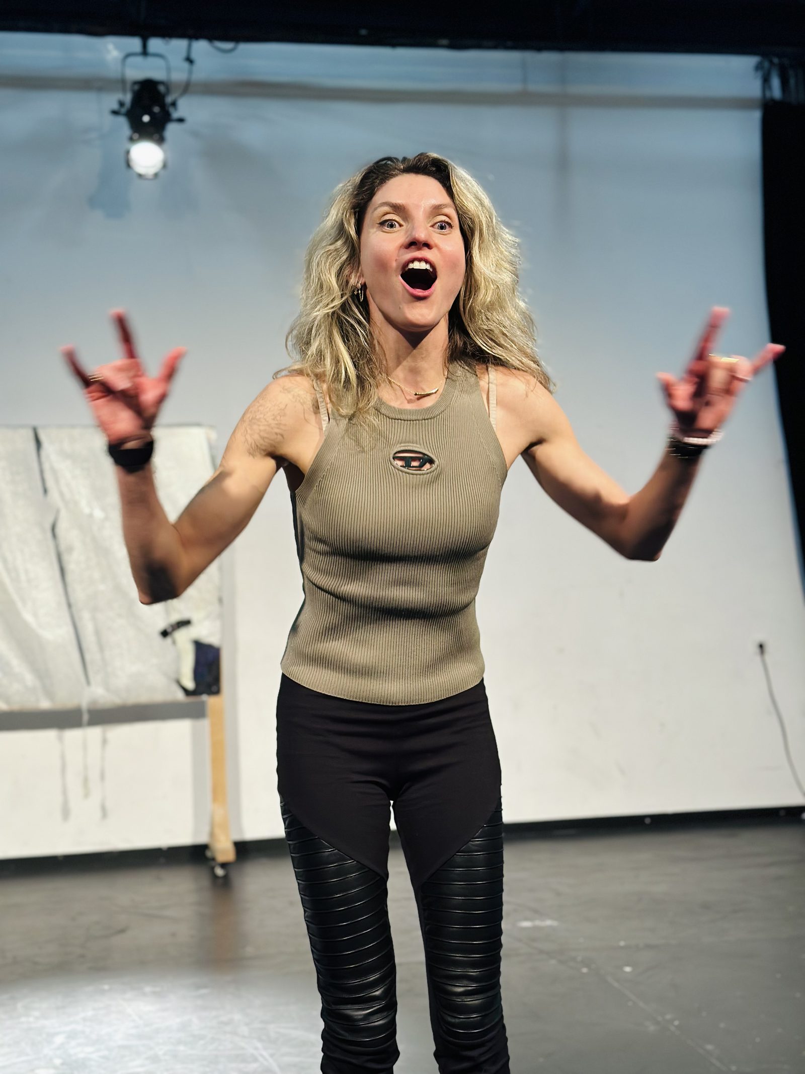 A workshop participant reacting with open surprise during an exercise, both hands raised
