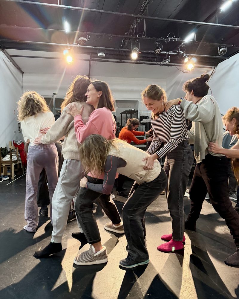 The group lifting one participant off the floor between them