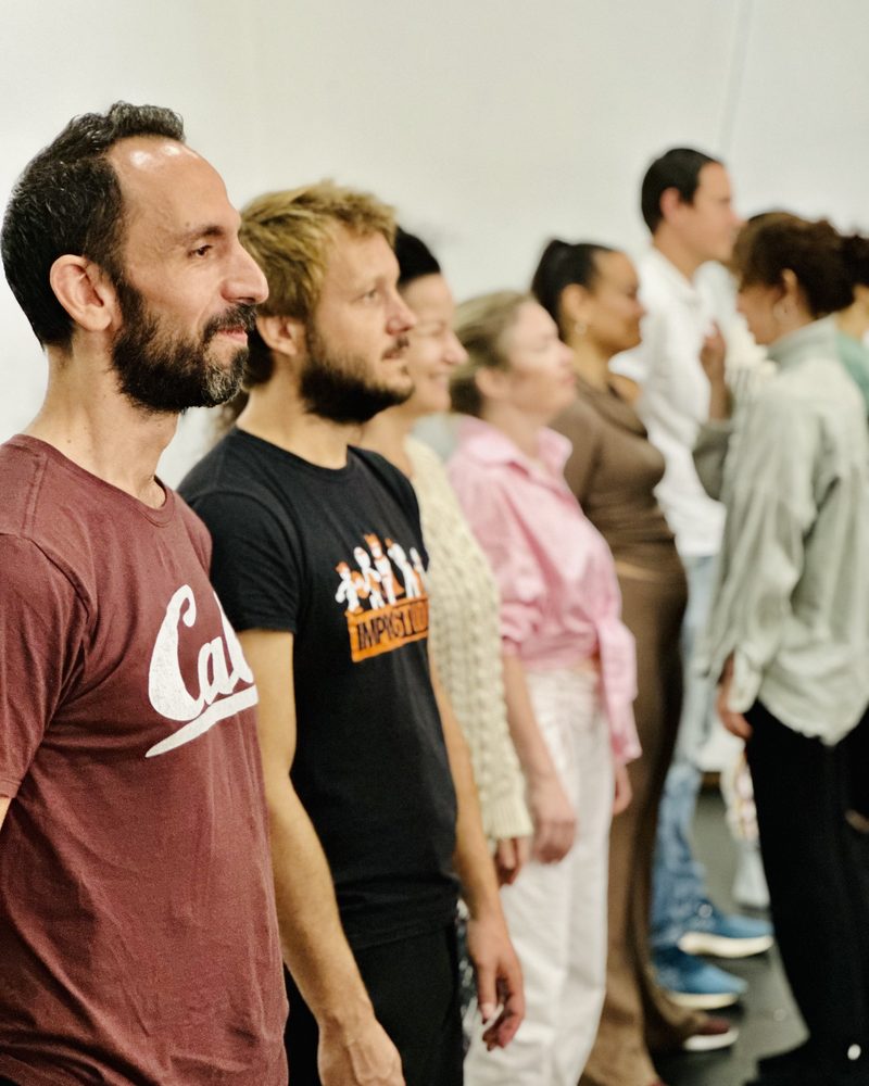 Two rows of participants standing face to face, waiting for the exercise to start