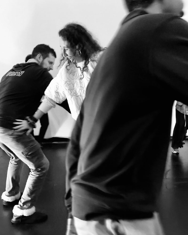Two participants crossing the room, blurred by their own movement