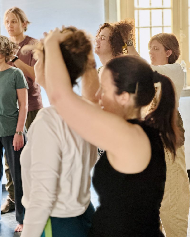Participants pressed close together with their arms raised
