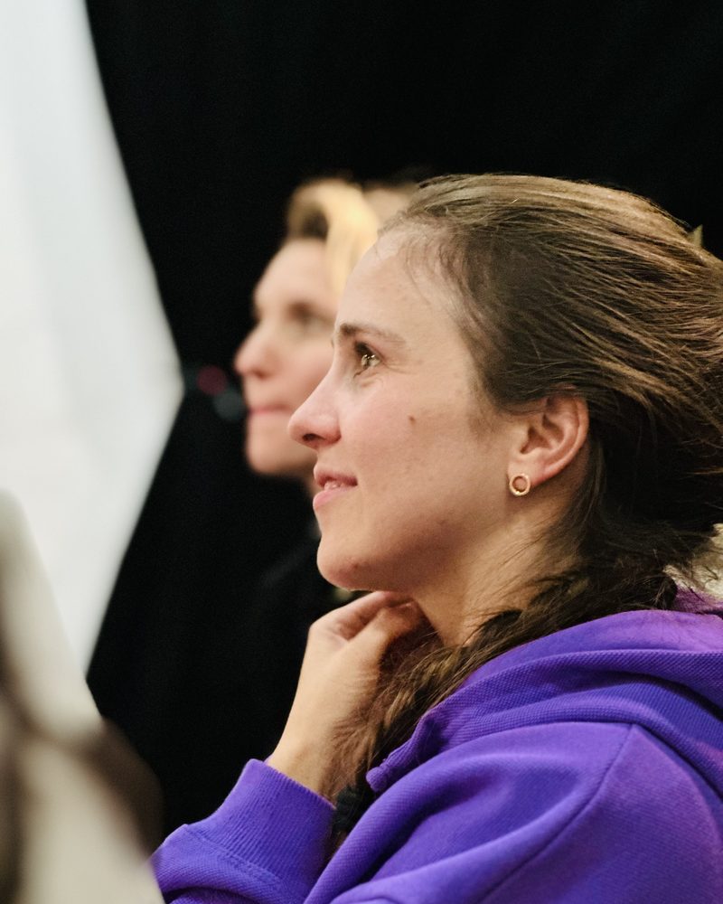 A participant watching in profile, chin resting on her hand