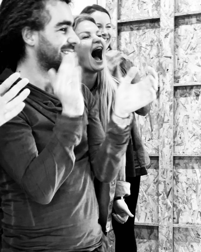 Two participants shouting together, hands raised