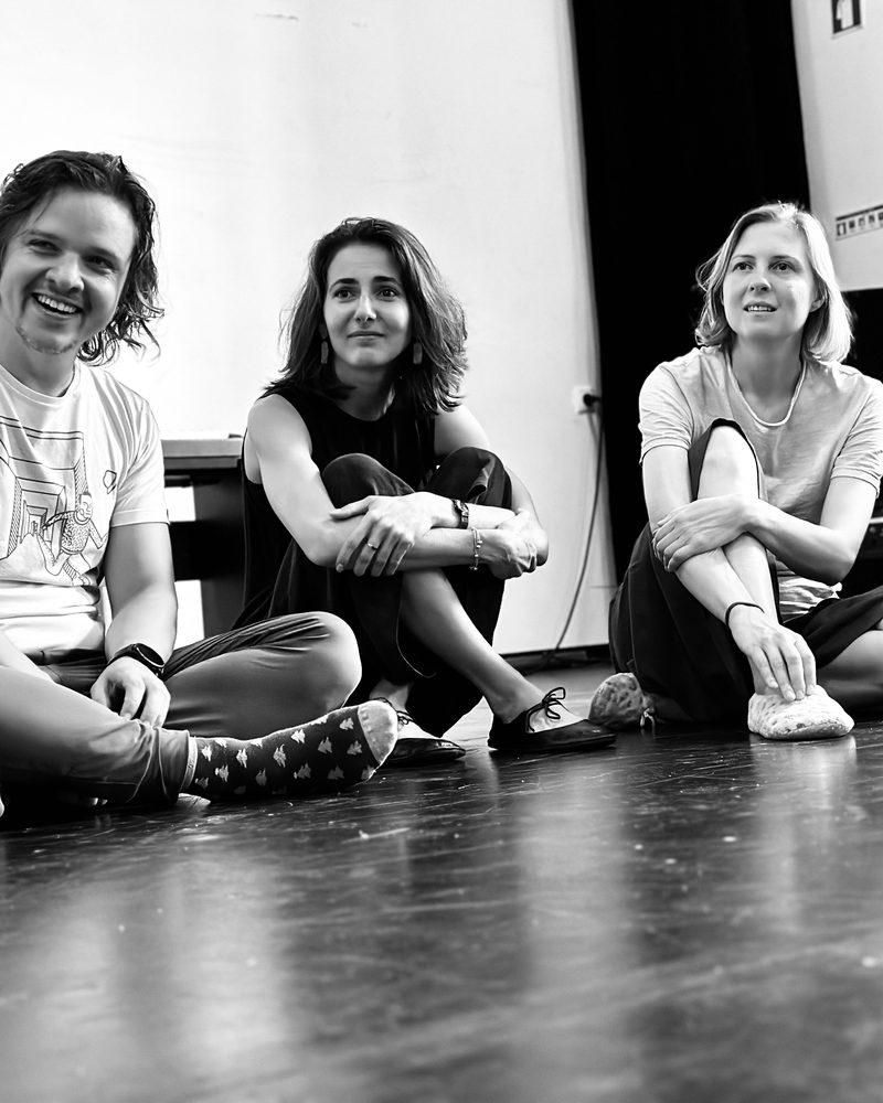 Four participants sitting along the wall between exercises