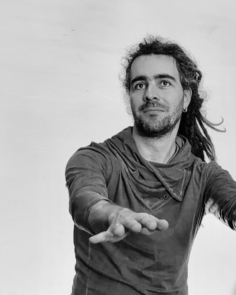 A participant alone against a white wall, one arm reaching out