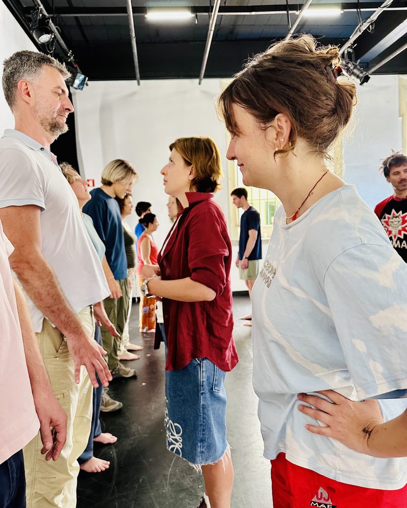 Two lines of participants meeting in pairs across the room