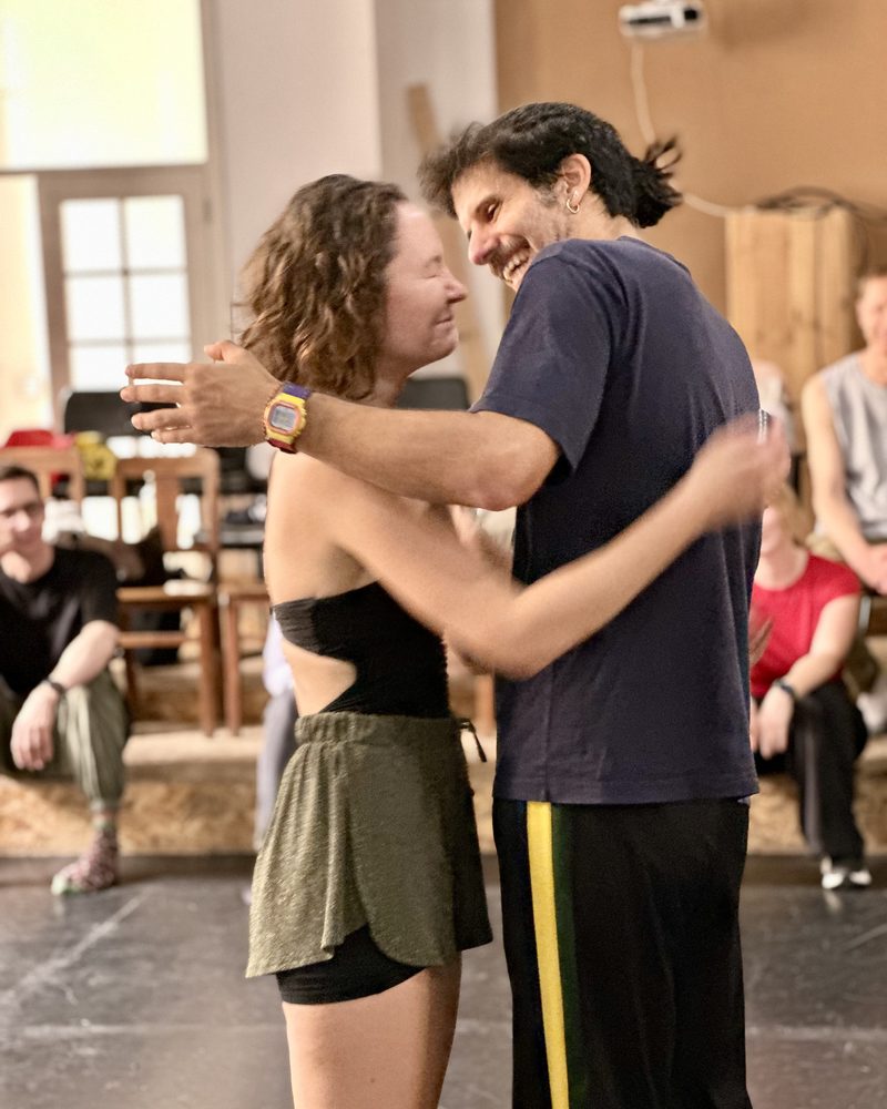 Two participants holding each other and laughing