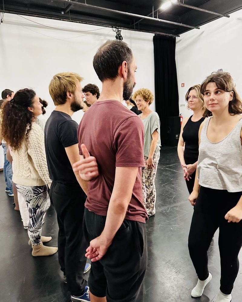 The group standing in a loose circle before an exercise