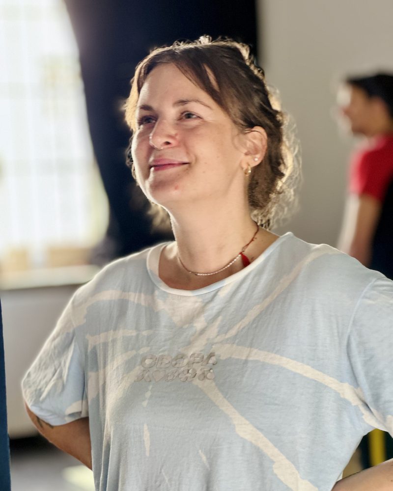 A participant listening quietly, half smiling